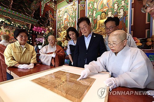 독립신문 설명 듣는 이재명 대통령 부부